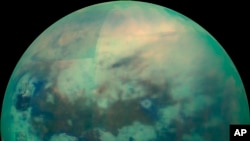 This Nov. 13, 2015 composite image made available by NASA shows an infrared view of Saturn's moon, Titan, as seen by the Cassini spacecraft. The near-infrared wavelengths in this image allow the cameras to penetrate the haze and reveal the moon's surface.