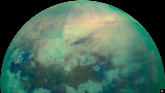 This Nov. 13, 2015 composite image made available by NASA shows an infrared view of Saturn's moon, Titan, as seen by the Cassini spacecraft. The near-infrared wavelengths in this image allow the cameras to penetrate the haze and reveal the moon's surface.