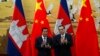 Cambodian Prime Minister Hun Sen, left, applauds with Chinese Premier Li Keqiang during a signing ceremony at the Great Hall of the People in Beijing, China, Tuesday, Jan. 22, 2019. (AP Photo/Ng Han Guan, Pool)