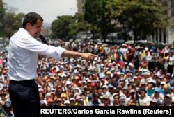 Venezuelan opposition leader Juan Guaido speaks to supporters during a rally against the government of President Nicolas Maduro and to commemorate May Day in Caracas, May 1, 2019.