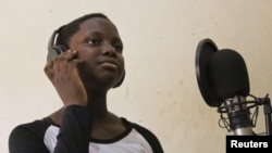 Rapper MC Loy, 13, records rap news to appeal to a younger audience, Kampala, March 20, 2014. (Hilary Heuler/VOA)