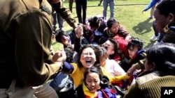 Indian police detain Tibetan exiles during a protest outside the Chinese Embassy in New Delhi, India, February 16, 2012.