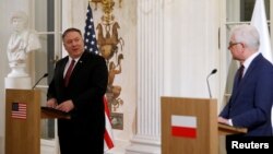 Polish Foreign Minister Jacek Czaputowicz and U.S. Secretary of State Mike Pompeo hold a news conference at Lazienki Palace in Warsaw, Feb. 12, 2019. 