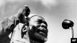 FILE - Jomo Kenyatta, leader of the Kenya African National Union, gestures with his fist as he speaks in Nairobi, Kenya, in 1962. 