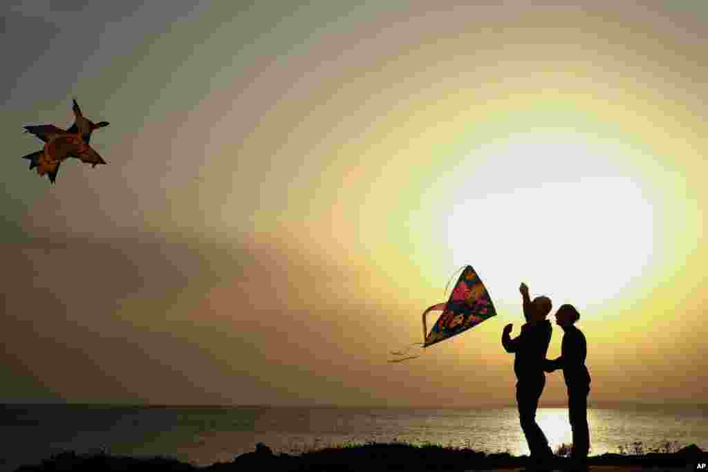 Men fly their kites during celebrations of the Orthodox Clean Monday in Ayia Napa, Cyprus.