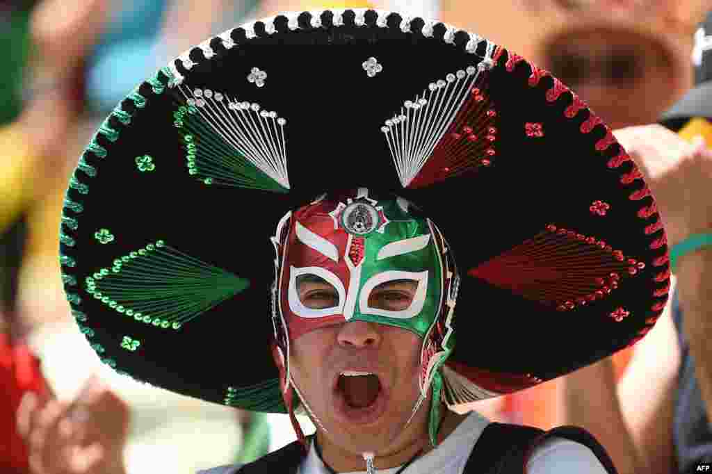 A Mexican supporter cheers for his team ahead of the Round of 16 football match between Netherlands and Mexico at Castelao Stadium in Fortaleza, Brazil, during the 2014 FIFA World Cup.