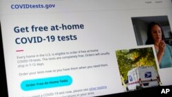 A U.S. government website is displayed on a computer, Jan. 19, 2022, in Walpole, Mass., that features a page where people can order free, at-home COVID-19 tests.