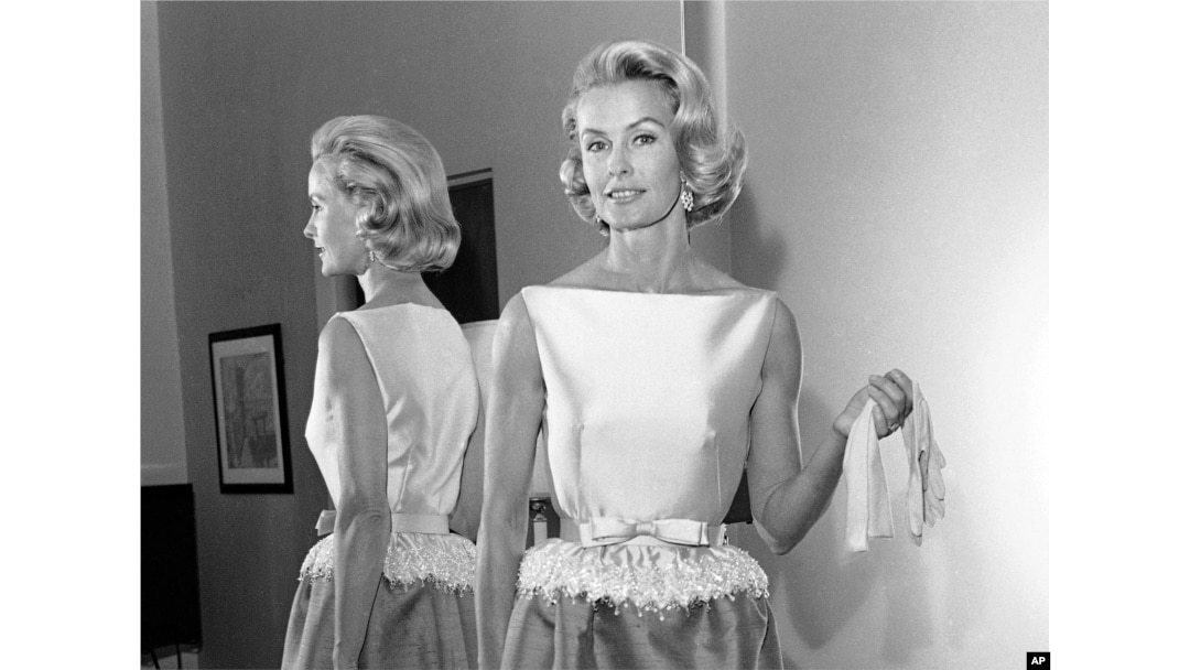 FILE - In this April 6, 1962, photo, socialite-actress Dina Merrill models the gown she was to wear at the Academy Awards presentation in Los Angeles. Merrill, the rebellious heiress who defied her super-rich parents to become an actress, died May 22, 2017, at age 93.