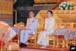 Thailand's King Maha Vajiralongkorn, left, and Queen Suthida sit at Bangkok City Pollar Shrine in Bangkok, Thailand, May 2, 2019.