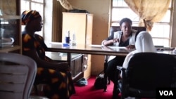 Mercy Philip (left) with her 8-year-old daughter (right in white) meet with a lawyer in northern Nigeria. 