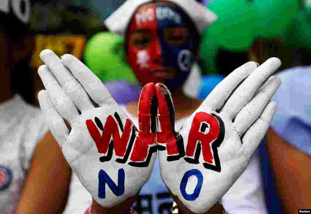 A girl with painted hands and face participates in a peace rally to commemorate the 73rd anniversary of the world's first atomic bombing in the Japanese city of Hiroshima during World War 2, in Mumbai, India.