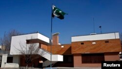 FILE - A Pakistani flag waves at the Pakistani embassy in Kabul.