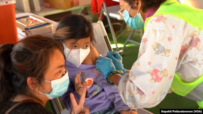 Cheri Bunyubol Kunsch,5, gets the first shot of the Pfizer COVID-19 vaccine, Nov. 28, 2021, at the Thai CDC’s vaccination mobile clinic at Wat Thai (Thai Temple) Los Angeles, Nort Hollywood, Los Angeles, CA.