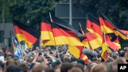 Demonstrators carry German flags during a rally in Chemnitz, eastern Germany, Sept. 1, 2018.