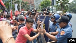Người biểu tình xô đẩy cảnh sát để đến gần Tòa Đại sứ Hoa Kỳ trong thủ đô Manila trước chuyến đến thăm của Tổng thống Obama, 23/4/14