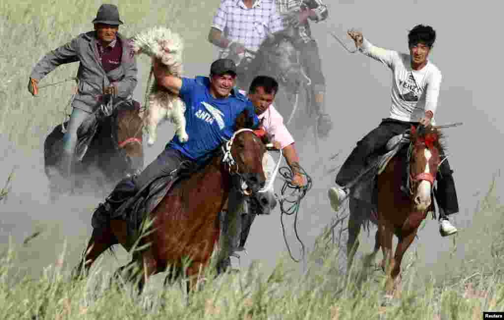 Participants ride horses as they compete for a goat carcass during a Buzkashi game in Bayingol, Xinjiang Uighur Autonomous Region, China September 6, 2018.