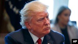 FILE - President Donald Trump listens in the Cabinet Room of the White House in Washington, March 29, 2017.