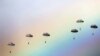 Russian paratroopers jump as a rainbow appears in the sky during the joint Russian, Belarusian and Serbian military exercise &quot;The Slavic Brotherhood&quot; at the military ground Kovin, near Belgrade.