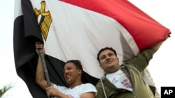 Supporters of President Abdel-Fattah el-Sissi wave a national flag as they celebrate in Mustafa Mahmoud Square after the election commission announced the presidential election results, in Cairo, April 2, 2018. The commission said el-Sissi has won a second, four-year term with more than 97 percent of the vote in last week's election, with turnout of 41.05 percent. 