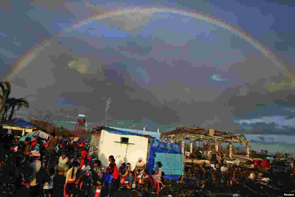A rainbow appears above Typhoon Haiyan survivors desperate to catch a flight from the Tacloban airport. The death toll from Typhoon Haiyan in the devastated Philippine coastal city of Tacloban was 4,000, a notice board at City Hall said on Friday, nearly double the nationwide toll provided by the government in Manila.