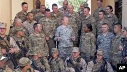 In this image released by the U.S. Department of Defense and taken Monday, Aug. 20, 2012, Army Gen. Martin E. Dempsey, chairman of the Joint Chiefs of Staff, talks to American service members with International Security Assistance Forces in Kabul, Afghani
