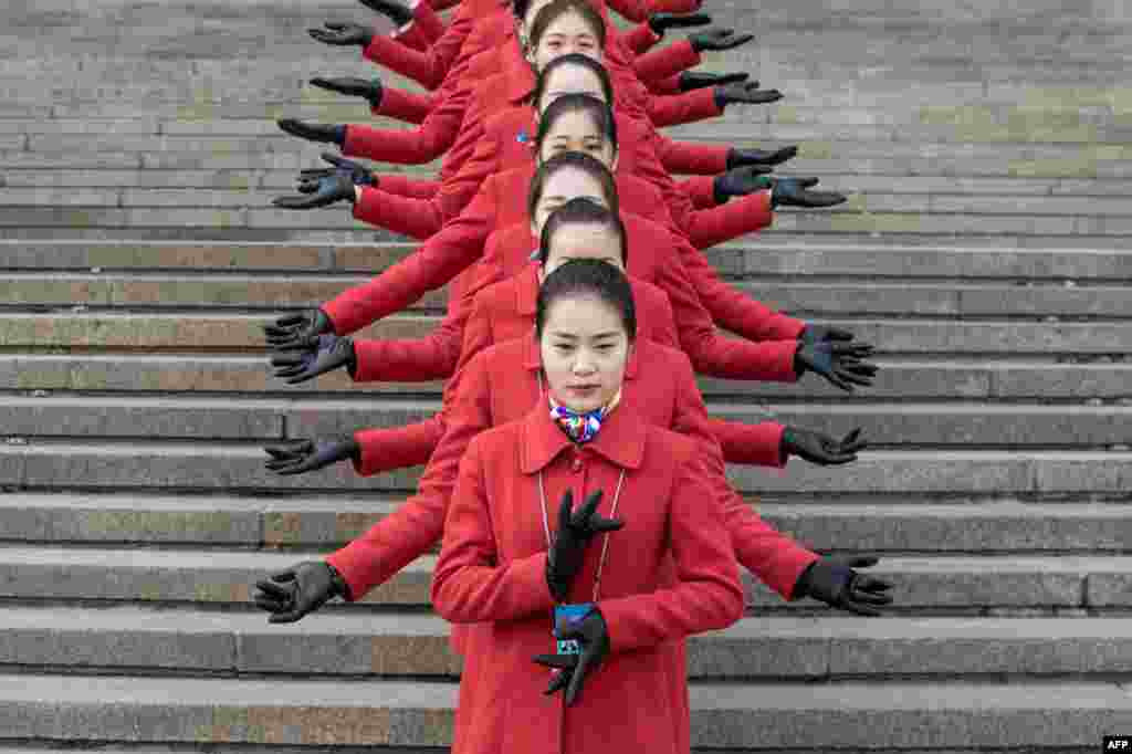 Hostesses pose for a picture during the opening session of the Chinese People&#39;s Political Consultative Conference (CPPCC) in the Great Hall of the People in Beijing. The CPPCC plays a largely symbolic role, with members meeting once a year to discuss social and economic policies.