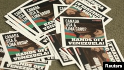 Leaflets thrown by protesters are seen during the closing news conference at the Lima Group meeting in Ottawa, Ontario, Canada, Feb. 4, 2019.