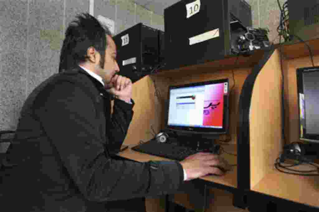 An Iranian man uses a computer in an internet cafe in central Tehran, Iran, Tuesday, Jan. 18, 2011. Iran's top police chief envisions a new beat for his forces: patrolling cyberspace. "There is no time to wait," Gen. Ismail Ahmadi Moghaddam said last week