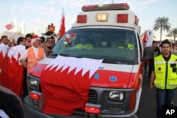 An ambulance draped in a Bahraini flag