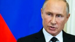 Russian President Vladimir Putin speaks to the media during a joint news conference with Hungarian Prime Minister Viktor Orban after their talks in the Kremlin in Moscow, Sept. 18, 2018.
