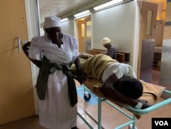 One patient, 48-year-old Phylis Mukundu, has suffered chest pains for more than a month and now struggles to walk and talk. She is seen here with her mother, Gertrude Ngoshi, at the Parirenyatwa Group of Hospitals.