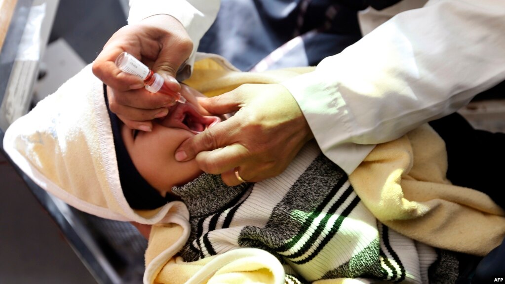 FILE - A Yemeni child receives a polio vaccination on the outskirts of the Yemeni capital Sanaa, on Dec. 11, 2017.