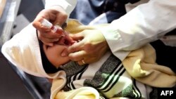 FILE - A Yemeni child receives a polio vaccination on the outskirts of the Yemeni capital Sanaa, on Dec. 11, 2017.