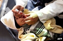 A Yemeni child receives a polio vaccination on the outskirts of the Yemeni capital Sanaa, on Dec. 11, 2017.