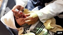 A child receives a polio vaccination on the outskirts of the Yemeni capital Sana'a, on Dec. 11, 2017.