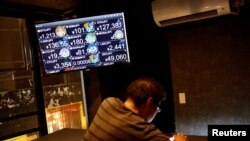 A monitor shows various cryptocurrencies' exchange rates against Japanese Yen including NEM coin (middle in the top) at a "nem bar," where customers can pay with NEM coins, in Tokyo, Japan, Jan. 29, 2018. 