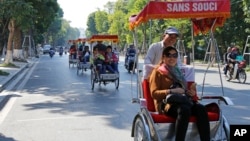 Chinese tourists ride rickshaws for sightseeing in Hanoi, Vietnam. The number of Chinese tourists visiting Vietnam has increased in recent years.