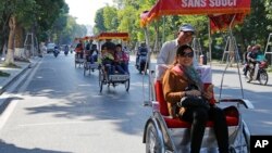 Chinese tourists ride rickshaws for sightseeing in Hanoi, Vietnam, Dec. 1, 2016.