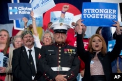 A member of the military stands in the audience as Democratic presidential candidate Hillary Clinton speaks at a rally at the Colorado State Fairgrounds in Pueblo, Colorado, Oct. 12, 2016.