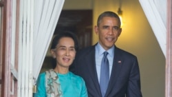 FILE - President Barack Obama, right, walks out with Myanmar's Aung San Suu Kyi at her home before the start of their joint news conference in Yangon, Myanmar.