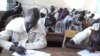 South Sudanese children sit for a high school exam in Aweil on March 20, 2013. The first ever national high school exams offered in the country have been marred by a shortage of test papers and poorly set questions. (VOA/Hou Akot Hou)