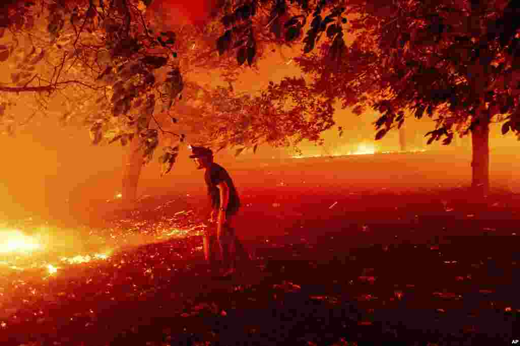 Matt Nichols tries to save his home as the LNU Lightning Complex fires tear through Vacaville, California.