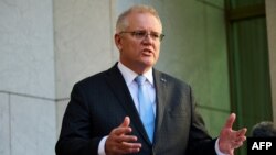 FILE - Australian Prime Minister Scott Morrison speaks during a press conference at Parliament House in Canberra, Aug. 17, 2021. 