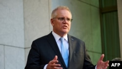 FILE - Australian Prime Minister Scott Morrison speaks during a press conference at Parliament House in Canberra, Aug. 17, 2021. 