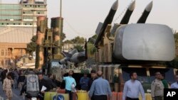 A Russian-made S-300 air defense system, left, is on display for the annual Defense Week, marking the 37th anniversary of the 1980s Iran-Iraq war, at Baharestan Sq. in Tehran, Iran, Sunday, Sept. 24, 2017. 