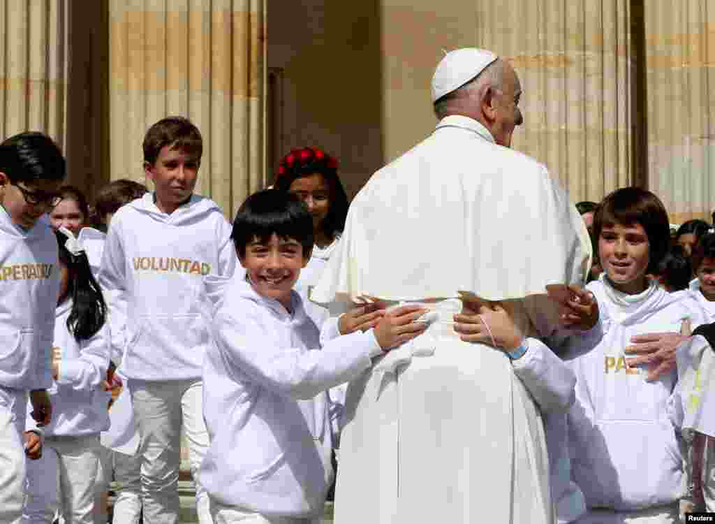 프란치스코 교황이 콜롬비아 보고타 대통령궁 앞 행사에서 어린이들의 환영을 받고 있다. 교황은 현지 방문 이틀째 후안 마누엘 산토스 대통령을 비롯한 정&middot;재계 지도자들을 만나, 반세기 내전에 따른 복수를 피해야한다고 호소했다.
