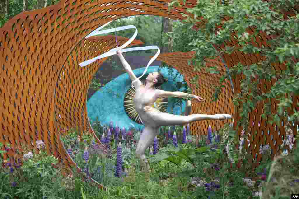 A dancer performs in The David Harber and Savills Garden at the 2018 Chelsea Flower Show in London.