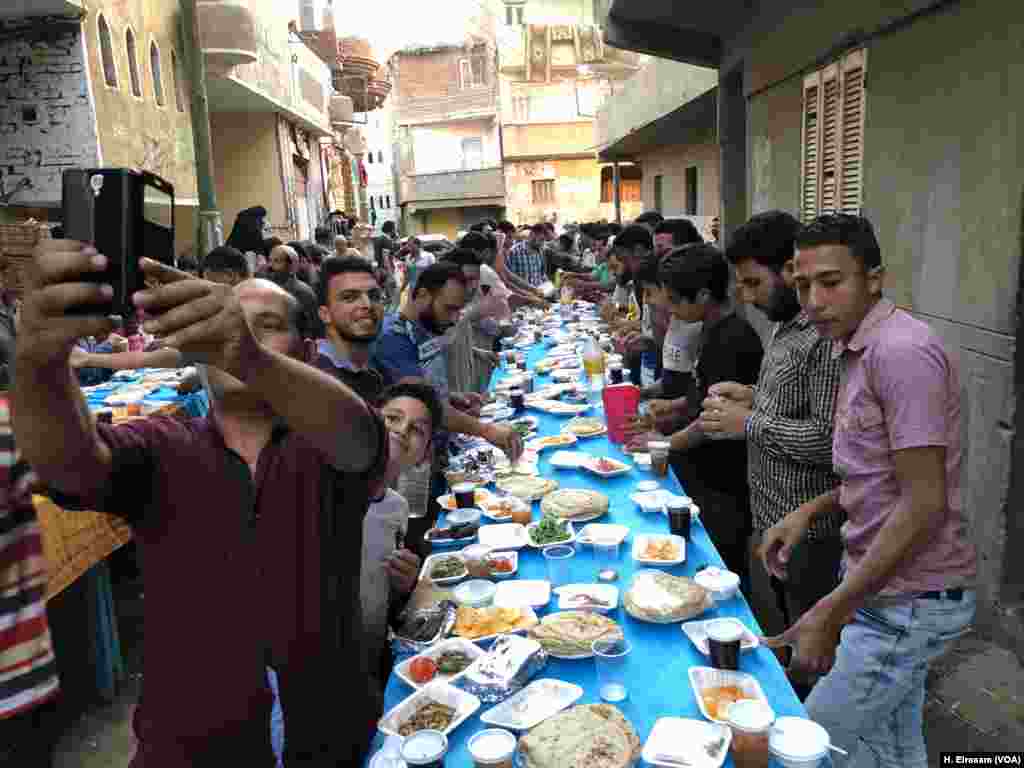 Nagrig residents gather to break the fast at a community Iftar during the Muslim holy season of Ramadan, sharing food, love and memories. They also talk about football.