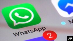 FILE - The WhatsApp messaging platform application appears on a smartphone, March 10, 2017.