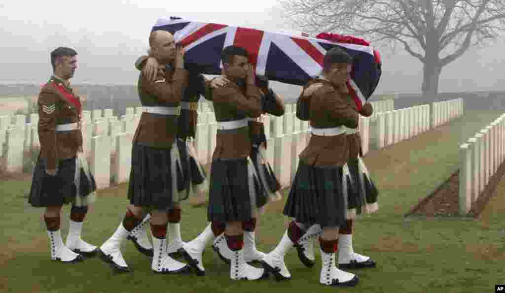 Military pallbearers carry the casket of British World War I soldier William McAleer during a reburial service at the Loos British World War I cemetery in Loos-en-Gohelle, France. Private William McAleer of the 7th Battalion, Royal Scots Fusiliers was killed in action on Sept. 26, 1915 during the Battle of Loos. His body was found and identified in 2010 during routine construction in the area and is being reburied with full military honors along with 19 unknown soldiers.